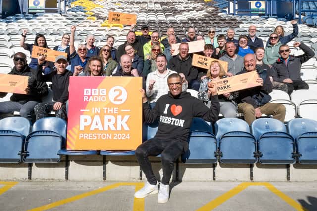 Richie Anderson at Deepdale Stadium with the lucky 40 people who received free pairs of tickets. Credit: BBC