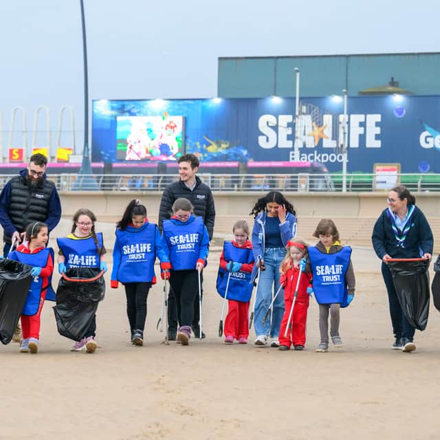 Sea Life Girlguides at a beach clean and badge presentation.