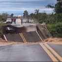 Bridge collapses and plunges into river.