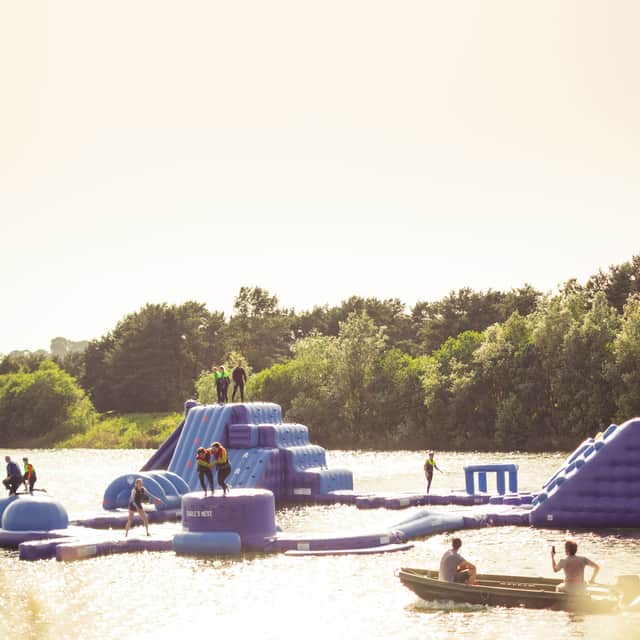 The Aqua Park is described as a ‘sprawling floating playground’ featuring tyre runs, ninja jumps, and slides.