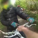 Police hiding in bushes jump out in front of scrambler bikes.