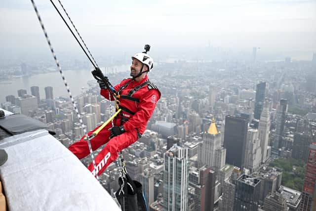 Blackpool's Alfie Boe abseilling down the Empire State Building.
