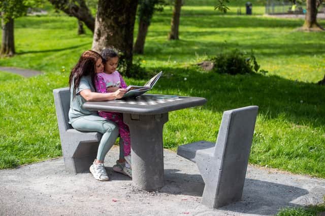 Leanne Leatherbarrow, 27, from Failsworth, with daughter Chanel Johnson, 8, using the chess table for reading and playing other games. 