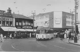 Trams used to run along Abingdon Street. Timothy Whites Chemist is in the back ground