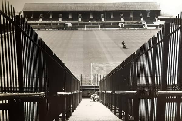 The caption on the back of this 1971 photo says 'A policeman's view of the Bloomfield Road pitch from the Kop which is being divided to split rival fans'