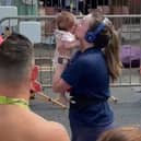 Megan McWhinney crosses the finish line at the Beaverbrooks Blackpool 10k with her 11-week-old daughter Fern