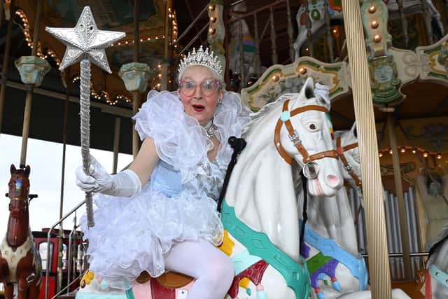 Su may be dressed as a Fairy Godmother but she can still enjoy a ride on a carousel horse!