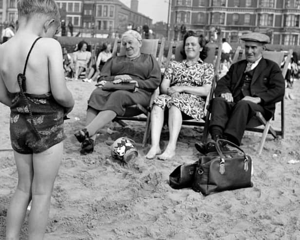 A child photographs his mother and grandparents on the beach, c1946-c1955. The Promenade provides a backdrop. (Photo by English Heritage/Heritage Images/Getty Images)