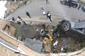 Dramatic moment speeding car ploughs into house before occupants flee scene