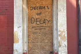 Decades of decay daubed across a door in Foxhall