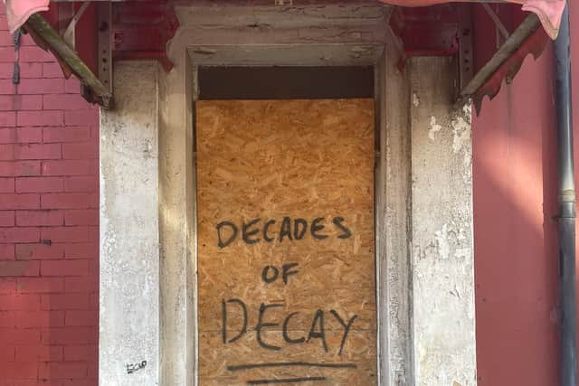 Decades of decay daubed across a door in Foxhall