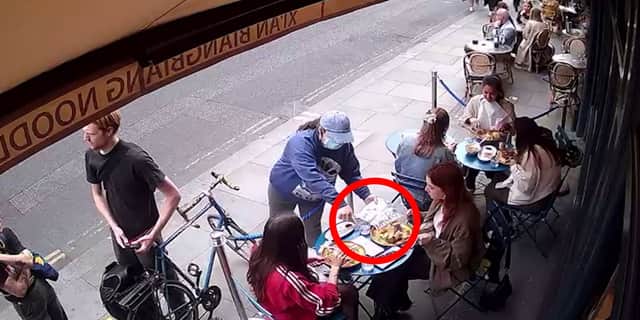 Pickpocket steals woman’s phone while she eats at restaurant.