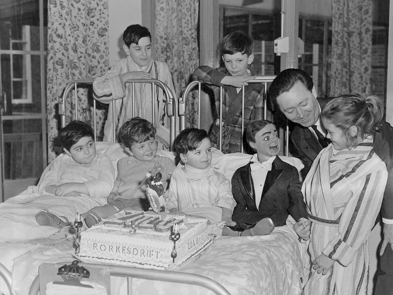 Arthur Worsley and Charlie Brown with a large "Zulu" cake at Blackpool Victoria Hospital childrens ward in 1963