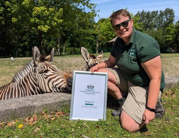 Keeper Sam at Blackpool Zoo with the Tripadvisor award
