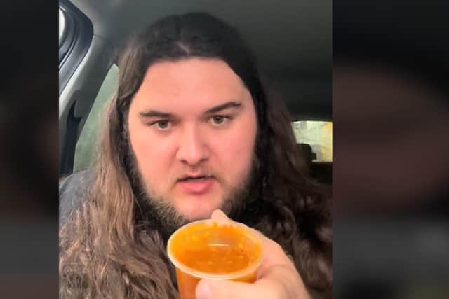 Kalani Ghost Hunter trying the curry sauce at Yorkshire Fisheries in Blackpool