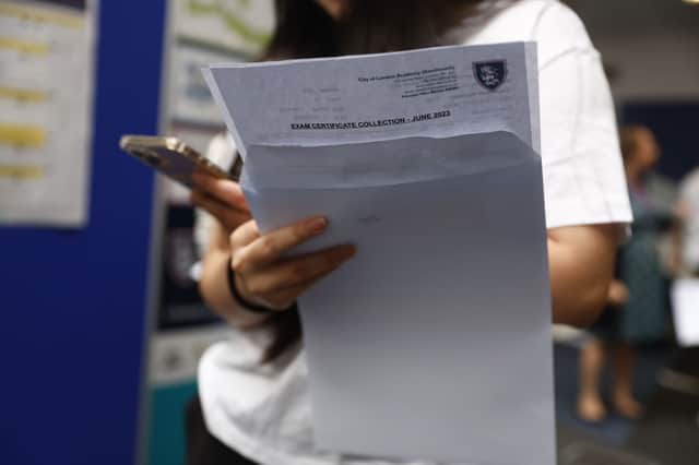 A student receives A-level results.