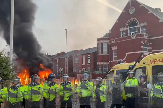 A police van set alight as trouble flares during a protest in Southport