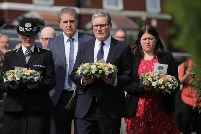 Prime Minister Keir Starmer is seen carrying a floral tribute near the scene in Hart Street