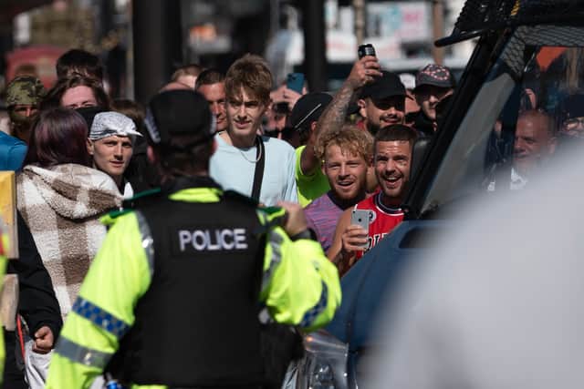 Violence ensued after a thugs threw objects - including glass bottles - at the police