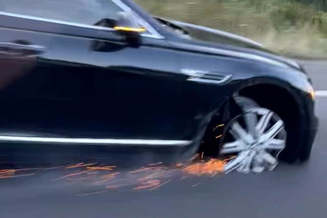 The Bentley Flying Spur driving along the M25 without a tyre.