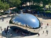 Chicago cityscape reflected in iconic Cloud Gate monument, known as 'The Bean'
