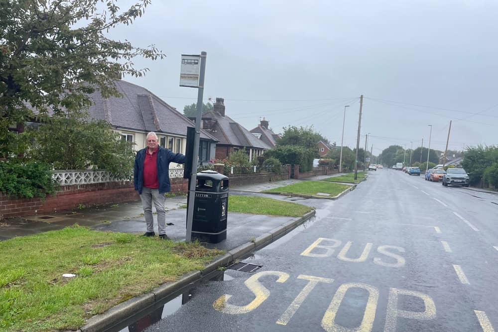  Coun Graham Baker at the bus stop on Midgeland Road which he and Coun Roberts are asking to be restored.
