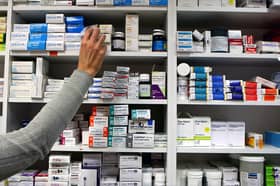 A pharmacist stocking shelves at a chemist