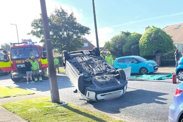 Emergency services attend crash which saw a car flip upside down in St ...