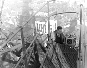 Red lamps are being placed at the top of Blackpool Tower as part of safety precautions by the Air Ministry, 1939