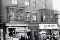 Talbot Road, Blackpool - south side between Abingdon Street and Topping Street. J.H. Berry & Son pork butcher and pie shop. Marlow's outfitters, Norwich Building Society, Charles Clayton and Co solicitors