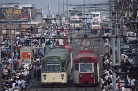 Trams and holidaymakers on the seafront of the seaside resort of Blackpool, Lancashire, August 1983