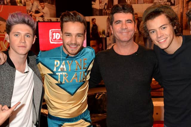 Simon pictured with Liam (centre) in happier times and Niall (far left) and Harry (far right). 