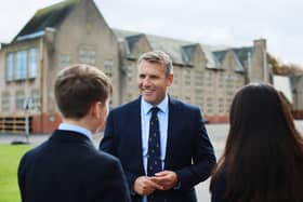Tallan Gill outside Kirkham Grammar School with two of its pupils.