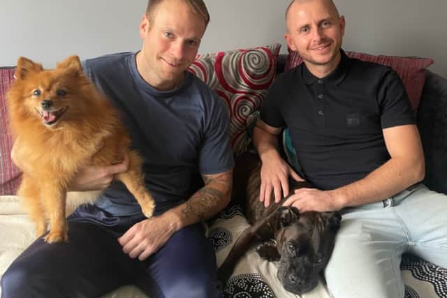Jacob Peake (left) and Northern Rail colleague Scott Grimes, with pomeranian, Kiki, and Molly the staffy