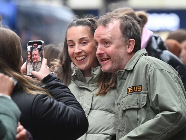 Comedian Chris McCausland poses with fans