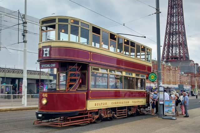 Passengers waiting to board a heritage tram on Blackpool Promenade