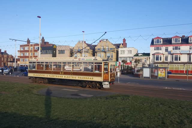 A heritage tram running along Blackpool Promenade