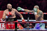 Britain's Tyson Fury (red) and Ukraine's Oleksandr Usyk (blue) compete during their heavyweight world championship rematch on December 22, 2024. Credit: AFP via Getty Images)