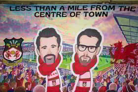 A banner of Wrexham owners Rob McElhenney and Ryan Reynolds (Photo by Jess Hornby/Getty Images)
