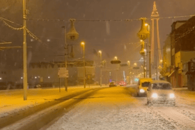 Snow falls in Blackpool coating roads and buildings.