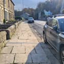 The gully can be seen dug out of the footpath, leading to the car