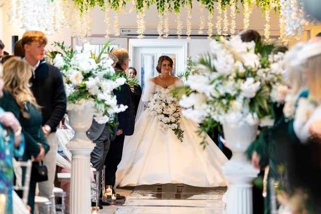 Katrina walks down the aisle at Holland Hall Hotel in Lancashire.