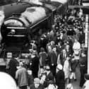Crowds admire the famous Flying Scotsman railway engine as it arrives at Blackpool North station 8th October 1966. It was decorated with the special nameplate  - Blackpool Belle  