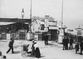 One of the earliest pictures of North Pier, taken in June  1897. The clocks showed the times of the sailings to Barrow and Southport.