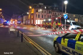 Police corden off Dickson Road last night as firefighters tackle the blaze at the junction with Wilton Parade