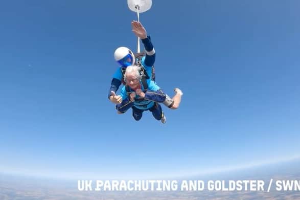 A 102-year-old lady skydiving with an instructor