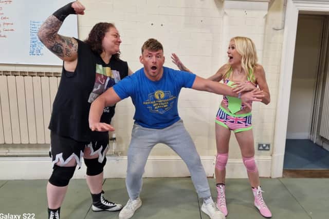 Wrestlers Taylor Valentine (left) and Sammy Rodgers get ready for their battle in the ring - trying to keep them apart is Blackpool wrestler and promoter, Ross Goodwin