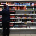 An employee stocks shelves at a Tesco supermarket in central London in 2021 (Photo: JUSTIN TALLIS/AFP via Getty Images)