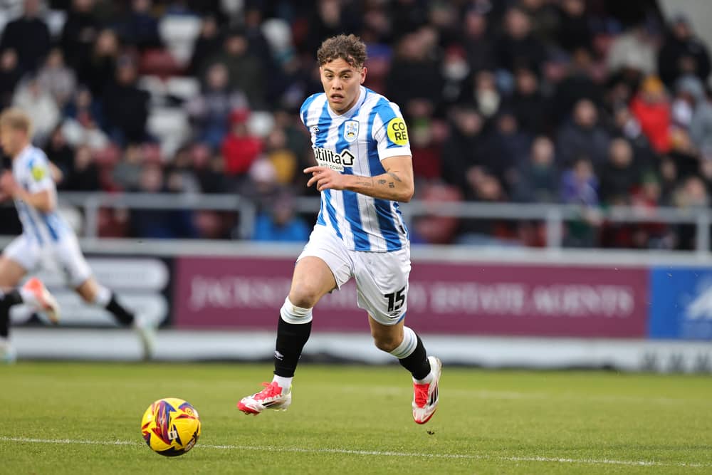 Dion Charles has apologised to Huddersfield after being spotted in Bolton's away end against Blackpool on Saturday.