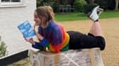 Author Charlotte Faulconbridge reading a book and smiling